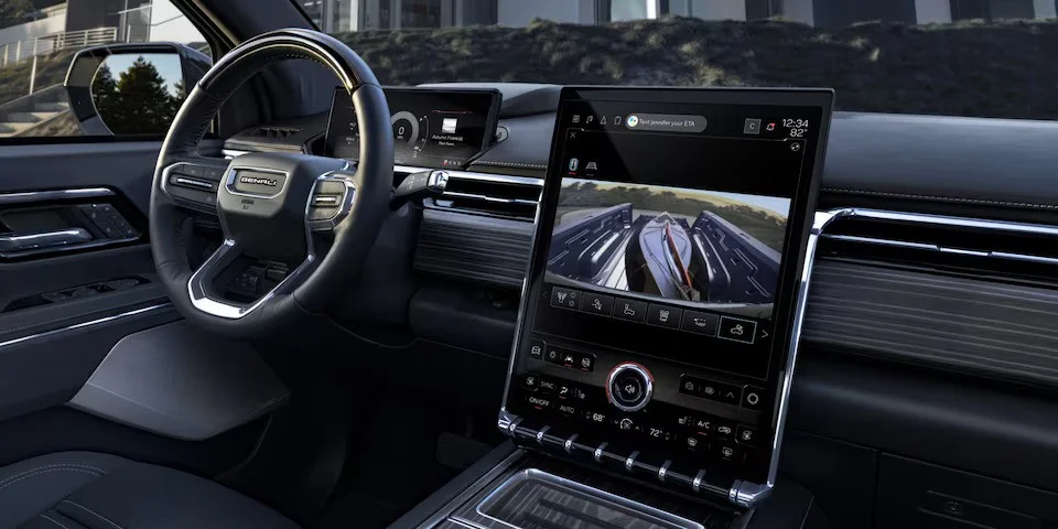 Interior View of the GMC Sierra EV's Steering Wheel and Infotainment System With the Truck Bed Camera in Use