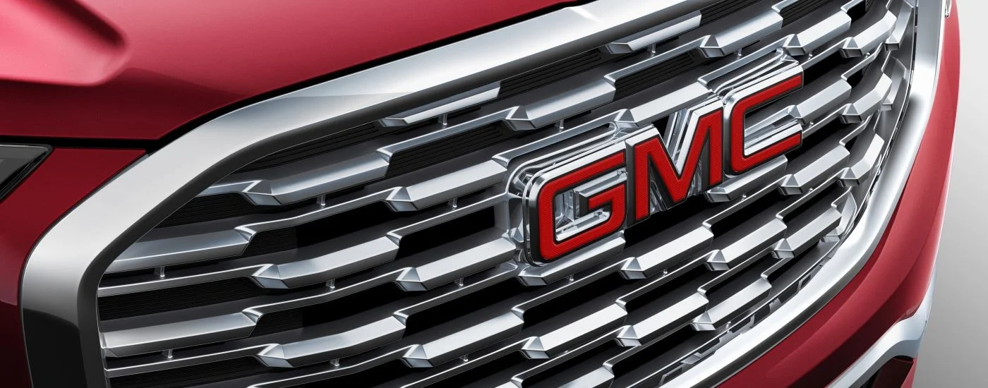 Close-up on the grille and logo of a red 2018 GMC Terrain Denali.
