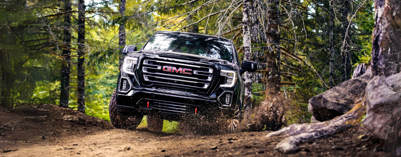 Front of a black 2019 GMC Sierra 1500 AT4 driving off-road.