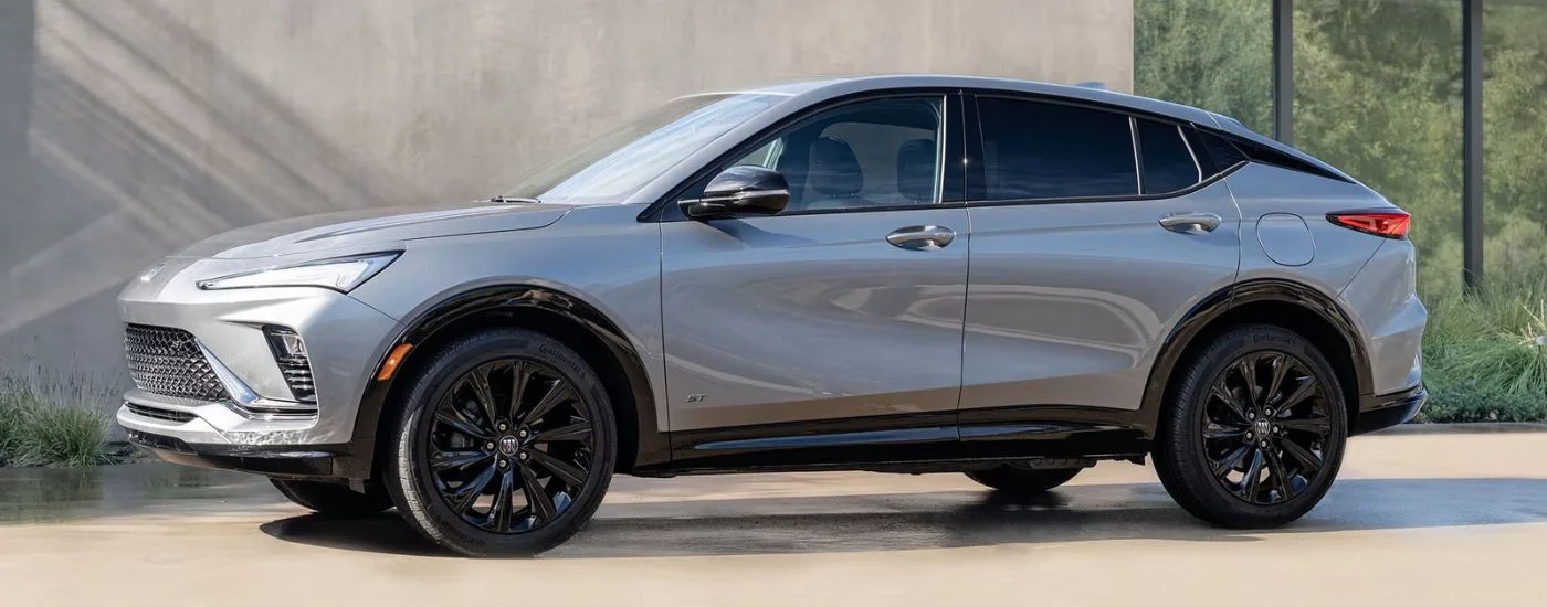 Side of a white 2025 Buick Envista ST parked near a building.