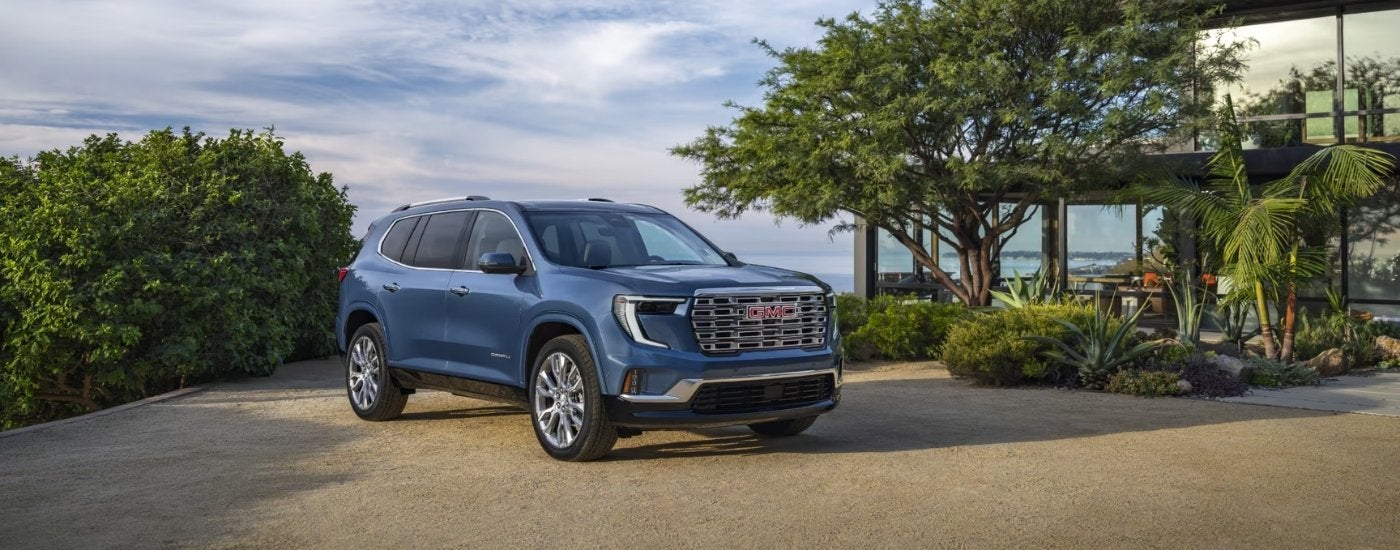 Blue 2025 GMC Acadia Denali parked on a driveway