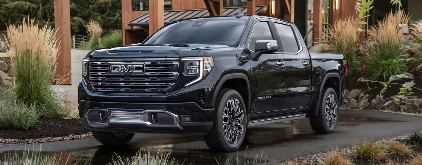 Black 2026 GMC Sierra 1500 Denali parked in a driveway.