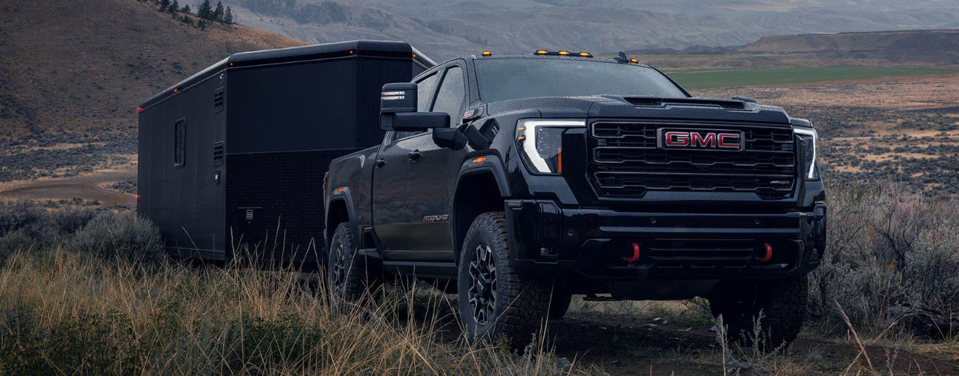 Black 2026 GMC Sierra 2500 towing a trailer