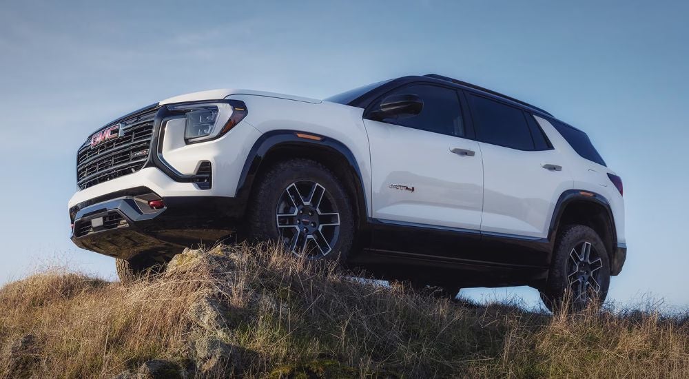 White 2027 GMC Terrain AT4 parked off-road.