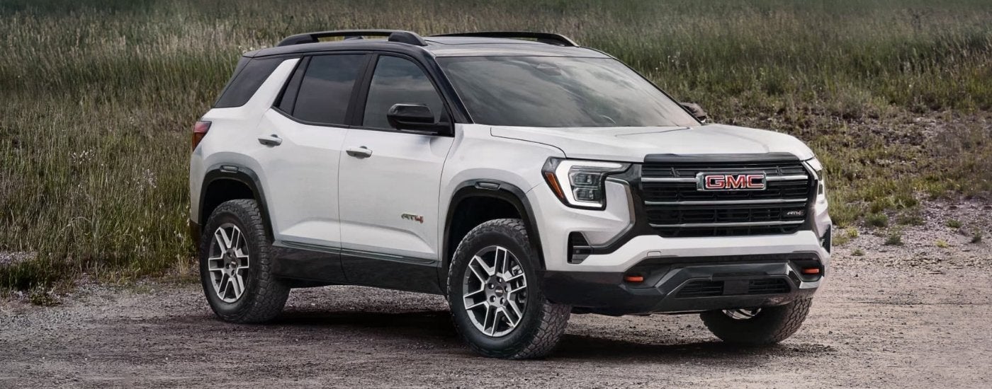 A white 2026 GMC Terrain AT4 parked on a sandy beach.