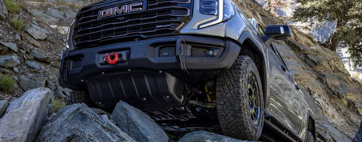 A silver 2025 GMC Sierra 1500 AT4X off-roading.